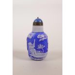 A Chinese blue and white Peking glass snuff bottle decorated with figures in a landscape scene, 3"