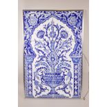 An Eastern blue and white six tile panel depicting an urn with flowers, 16" x 24", A/F