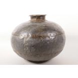 A bulbous riveted metal water carrier, 13" diameter