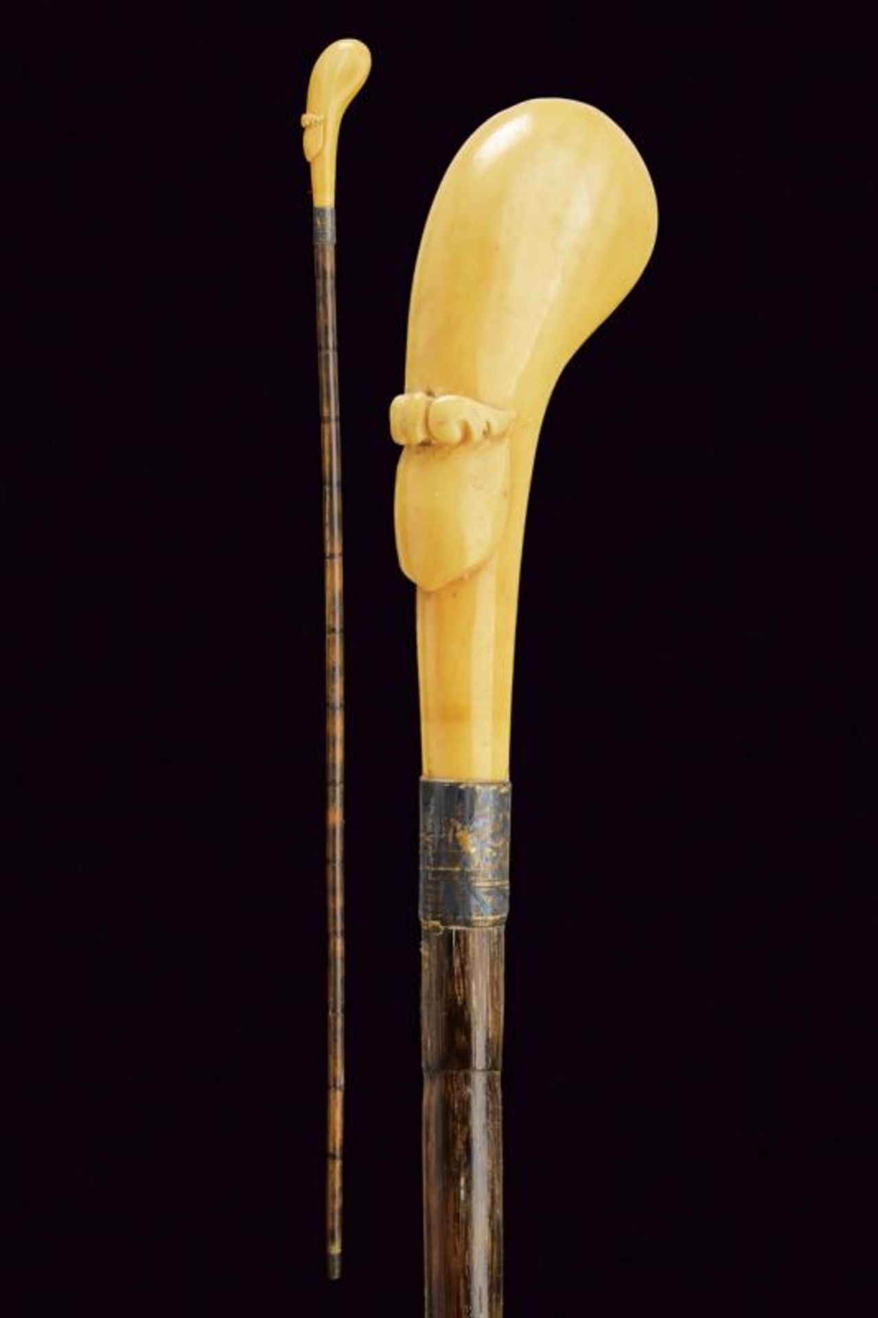 A walking stick with carved ivory grip