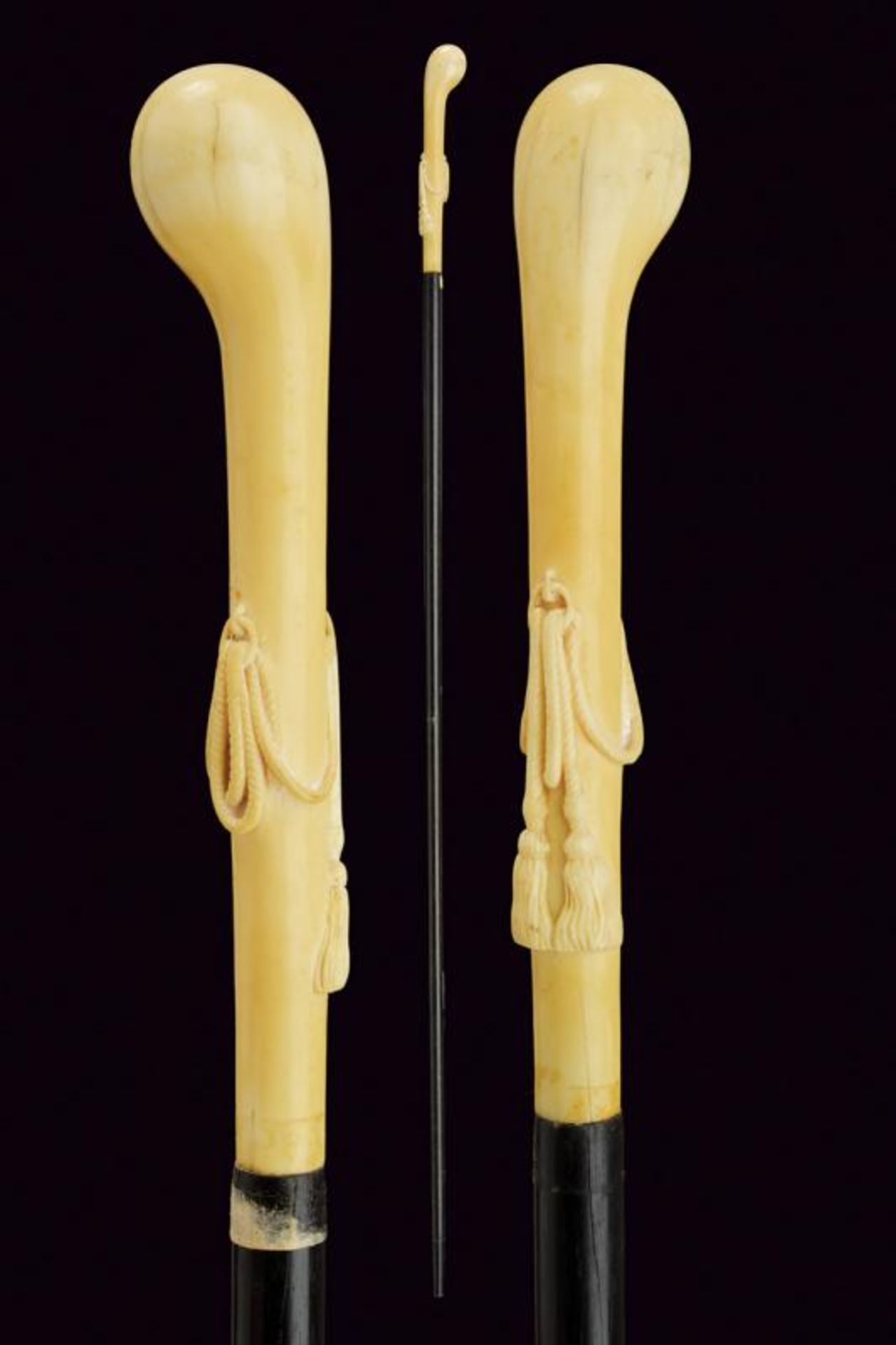 A walking stick with carved ivory grip