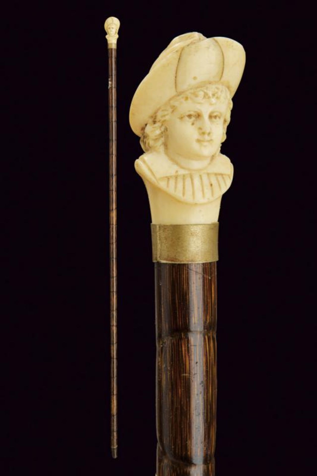 A walking stick with carved ivory grip
