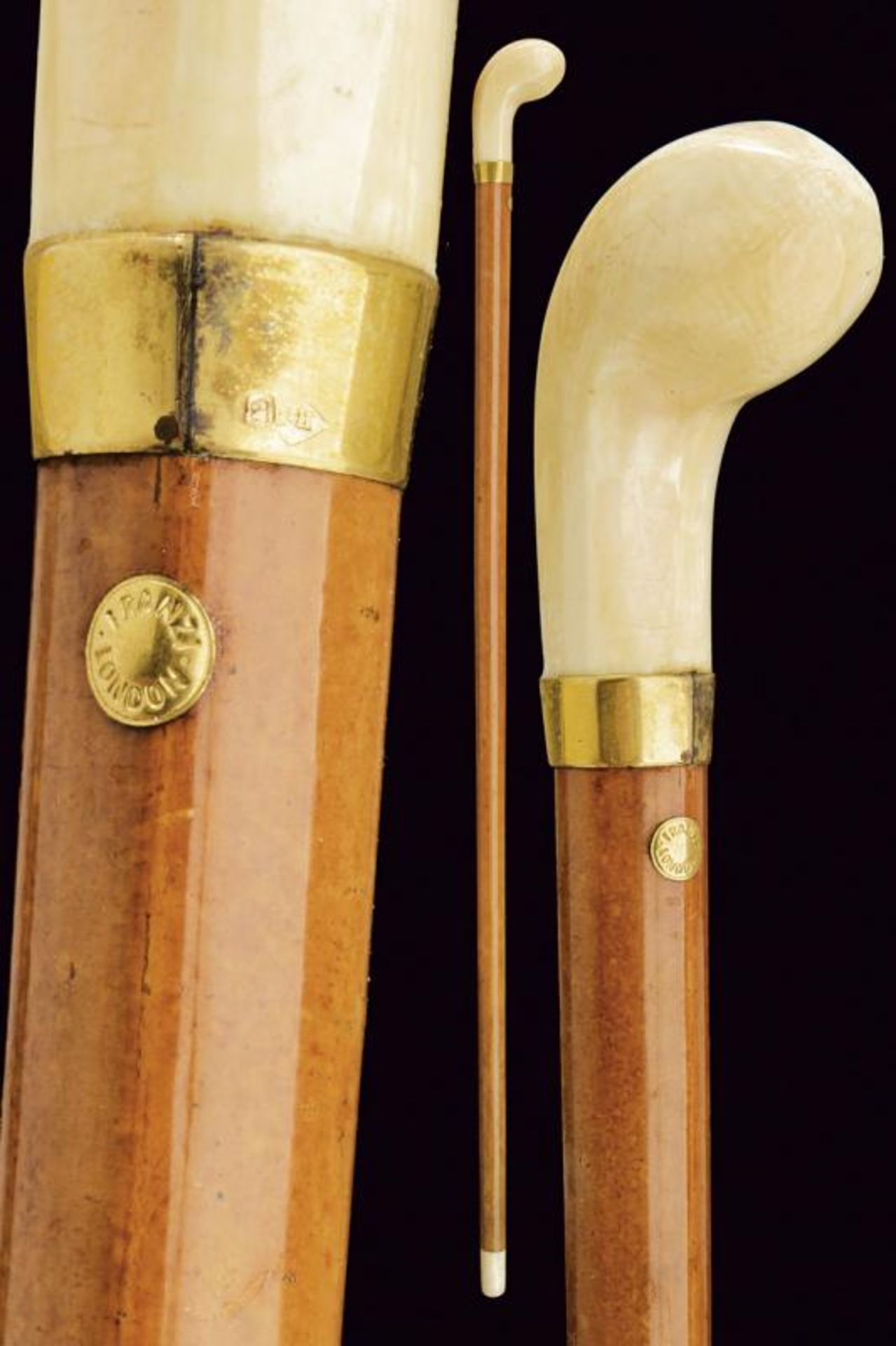 A walking stick with carved ivory grip