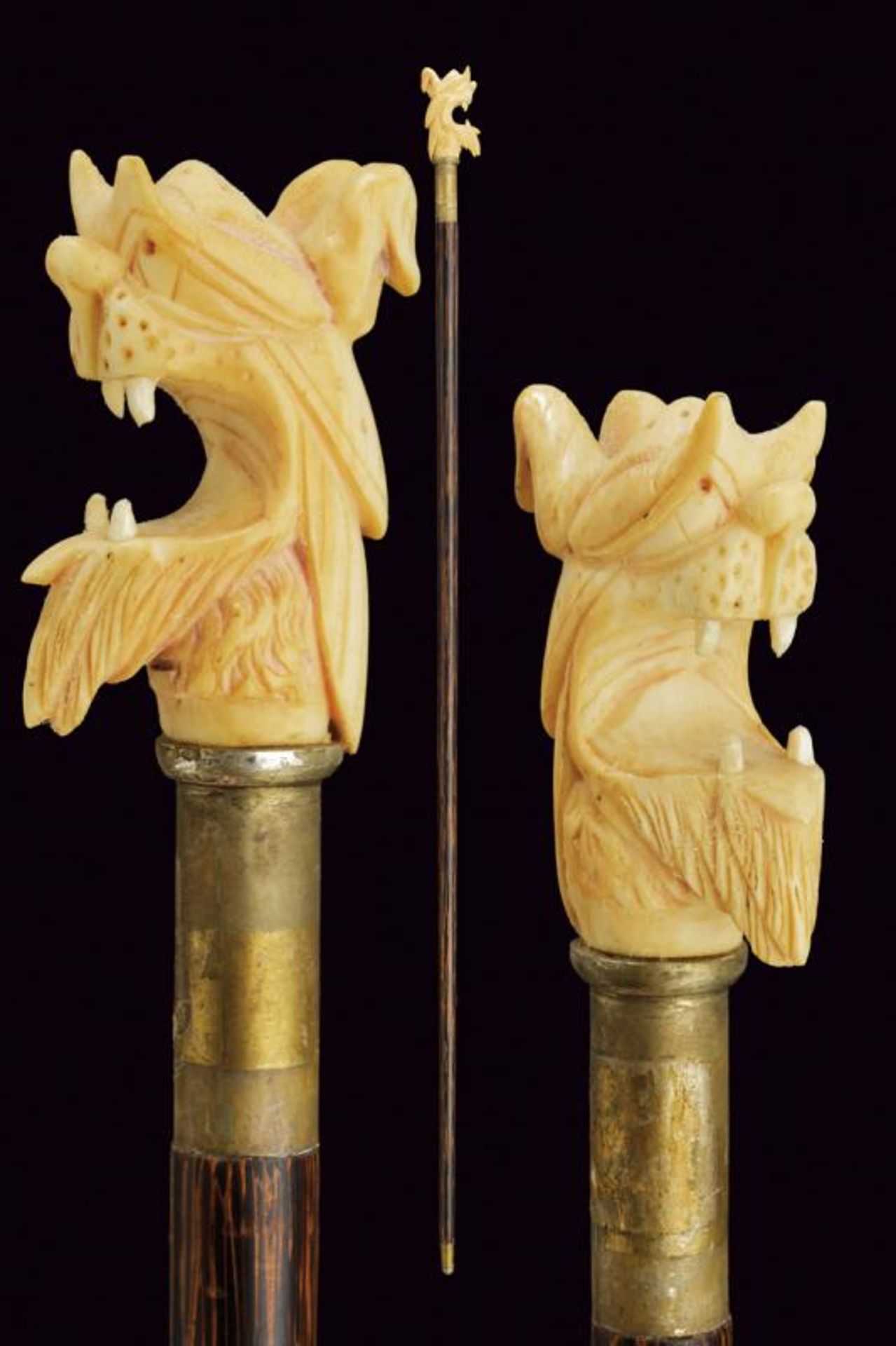 A walking stick with carved ivory grip