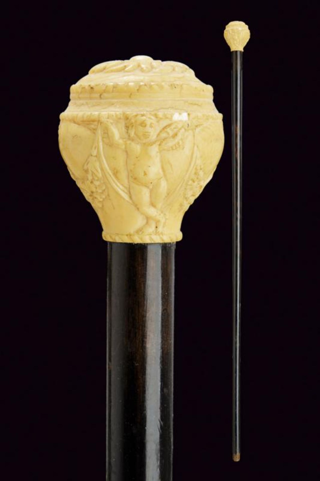 A walking stick with carved ivory grip