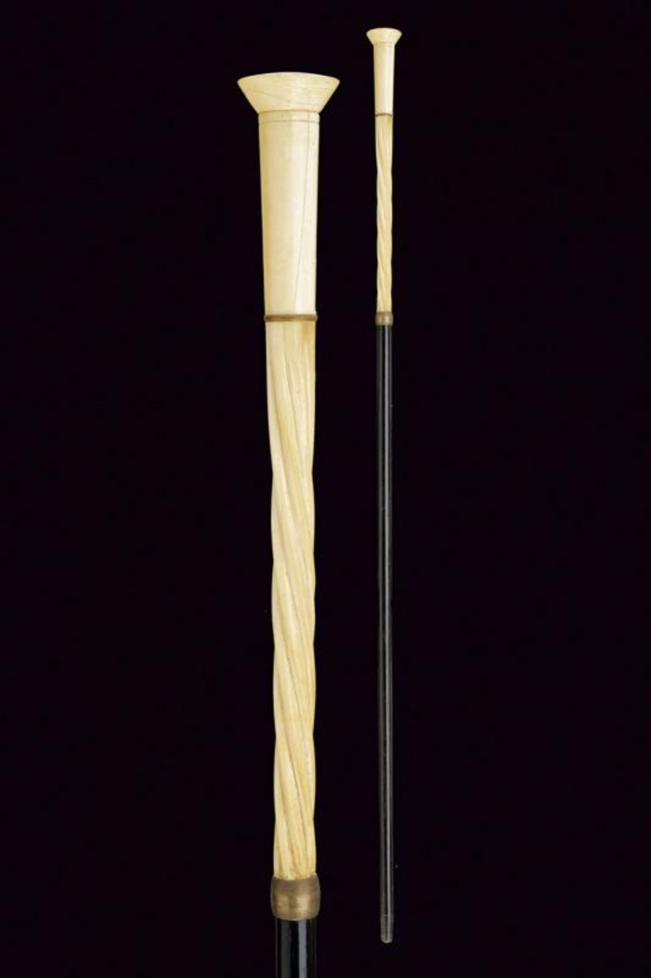 A walking stick with carved ivory grip