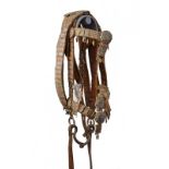 A rare snaffle bit with bridle, straps and reins