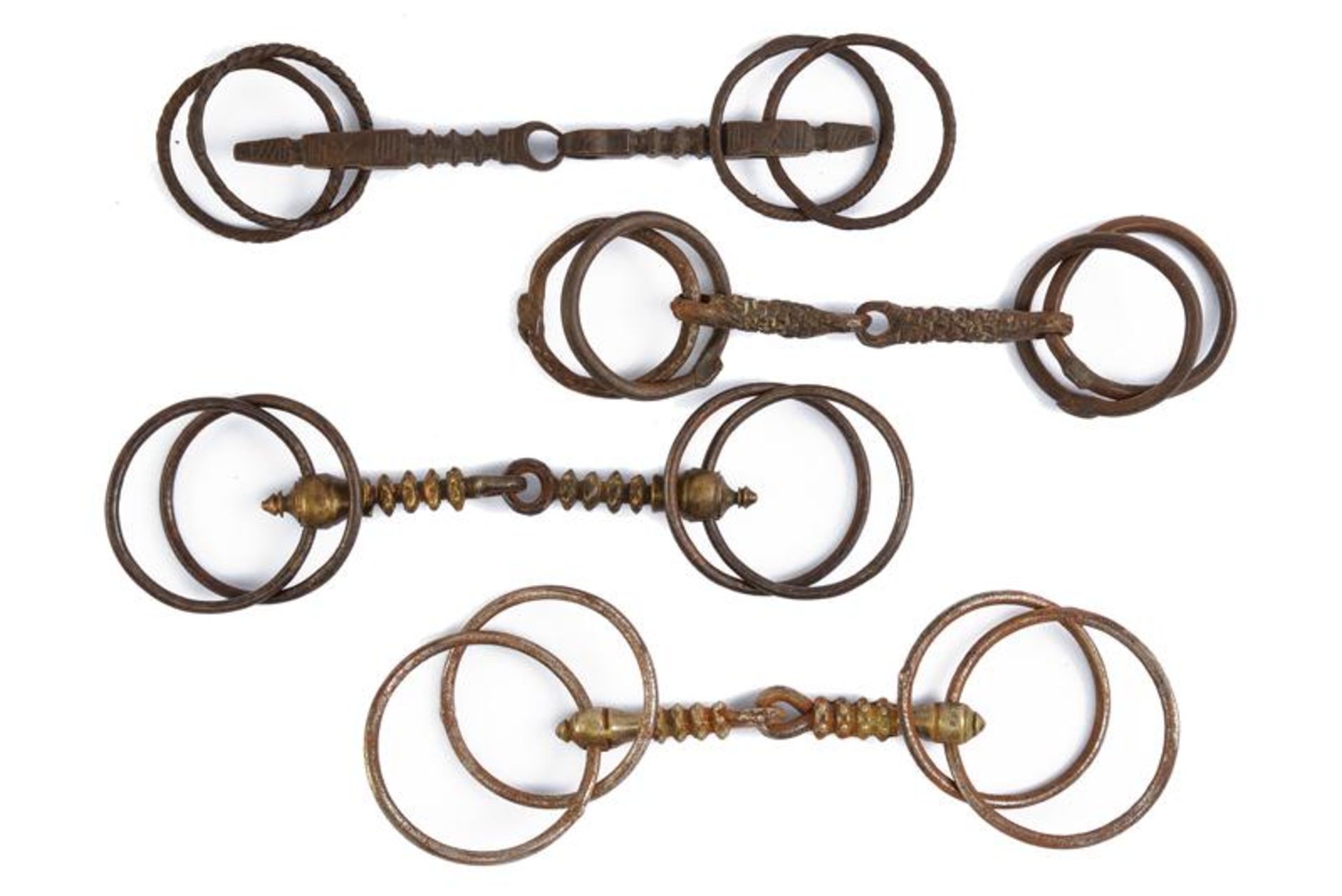 A lot of four snaffle horse bits
