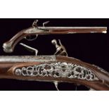 A flintlock pistol with finely chiseled iron mounts