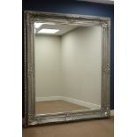 Large rectangular bevelled edge wall mirror in ornate swept silvered frame,