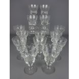 Set of six early Edwardian cut glass wine glasses etched with grapes and vines and a set of eight