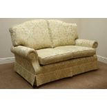 Two seat sofa upholstered in patterned fabric with scatter cushions,