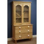 Victorian waxed pine bookcase on chest, glazed bookcase above two short and two long drawers,