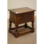 Medium carved oak joint stool with hinged top, front carved with rose head and foliage, W43cm,