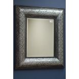 Embossed silver framed wall mirror, bevelled glass,