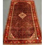 Persian Hamadan red and blue ground rug, repeating Herati motif field,