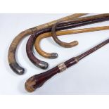 Three walking sticks with hallmarked silver mounts,