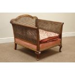 Early 20th century walnut framed bergere armchair, double caned sides on cabriole legs, W74cm,