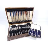 Set of cased early 20th Century silver coffee spoons and a canteen of stainless steel cutlery,