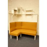 Edwardian white painted corner settee, high panelled back with raised corner cupboard and shelves,