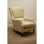 Curved back armchair upholstered in neutral fabric,