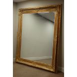 Large rectangular bevelled edge wall mirror in ornate swept gilt frame,