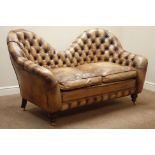 Two seat traditional sofa upholstered in deeply buttoned antique brown leather,