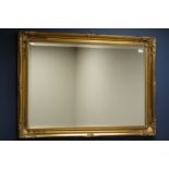 Rectangular bevel edged mirror in swept gilt frame,