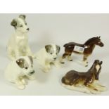 Russian animal figurines - two seated puppies and a terrier dog and two bay horses,