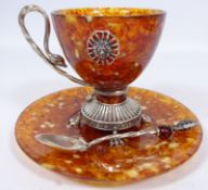 Russian white metal and amber cup, saucer and matching tea spoon,