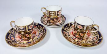 Two Royal Crown Derby Imari pattern coffee cans and saucers,