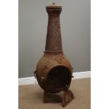 Cast iron chiminea decorated with grape vines,