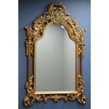 Ornate wall mirror in gilt frame with shaped top, W90cm,