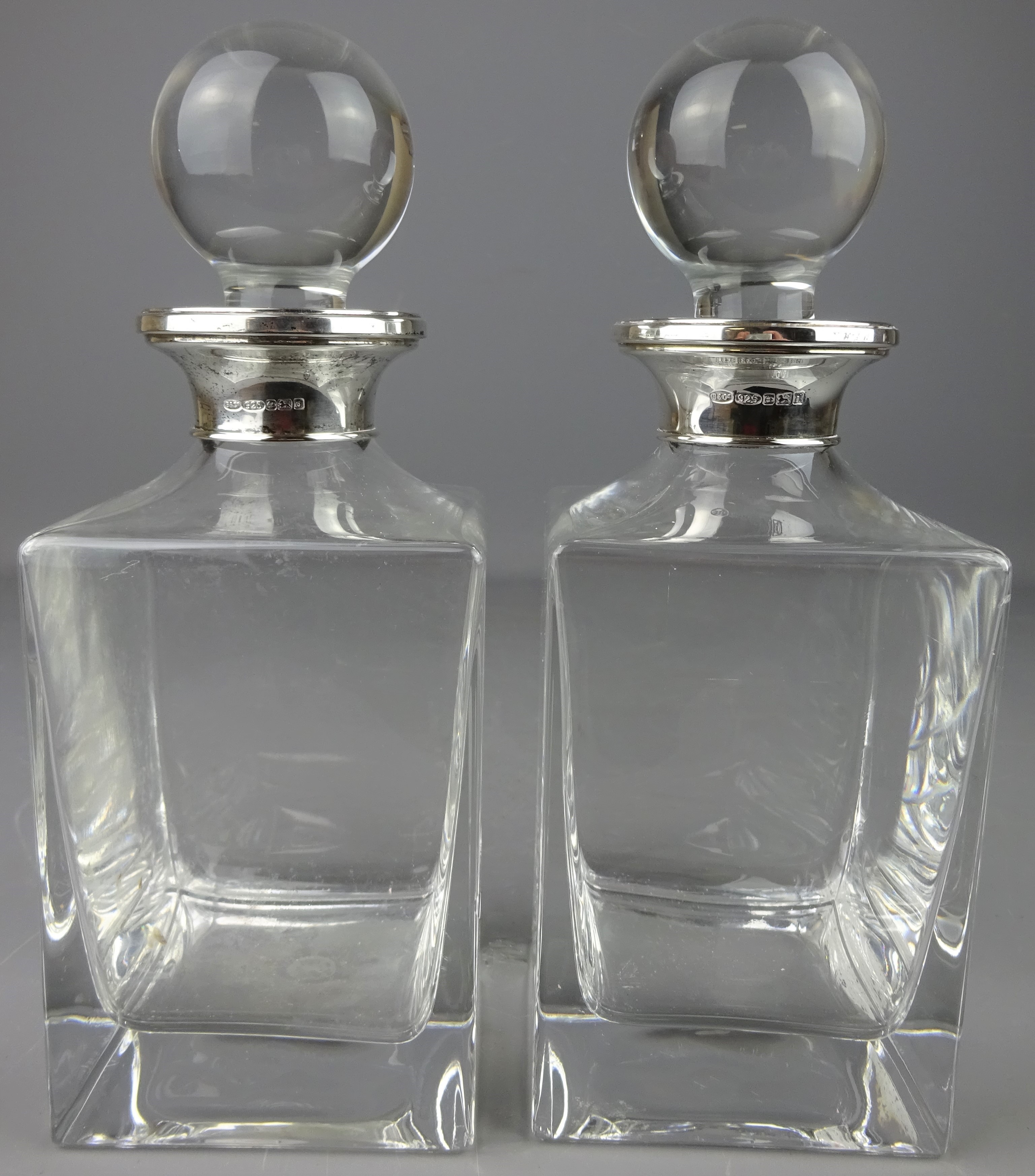 Pair of square form glass decanters with silver collars by W I Broadway & Co, Birmingham, 2003, H21.