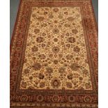 Persian design Tabriz beige ground rug, with multiple red borders, interlacing floral design,