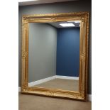 Large rectangular bevelled edge wall mirror in ornate swept gilt frame,