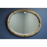 Oval gilt cushion framed wall mirror,