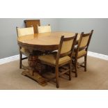 20th century oak extending dining table, strap work frieze, on twin carved baluster supports,