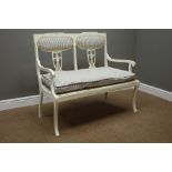 Edwardian white painted two seat settee upholstered in blue striped fabric,
