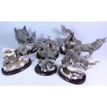 Seven Wolf group sculptures, mostly with stands,