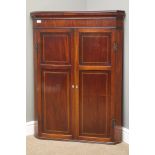 George III figured mahogany corner cabinet, two inlaid panelled doors,
