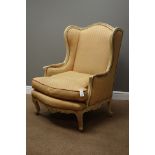 20th century French painted beech framed upholstered wingback armchair,
