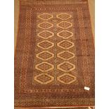Persian Bokhara design peach ground rug,