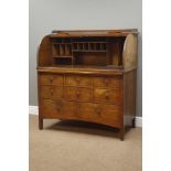 Early 20th century oak desk, tambour roll top enclosing fitted interior, eight drawers, W112cm,