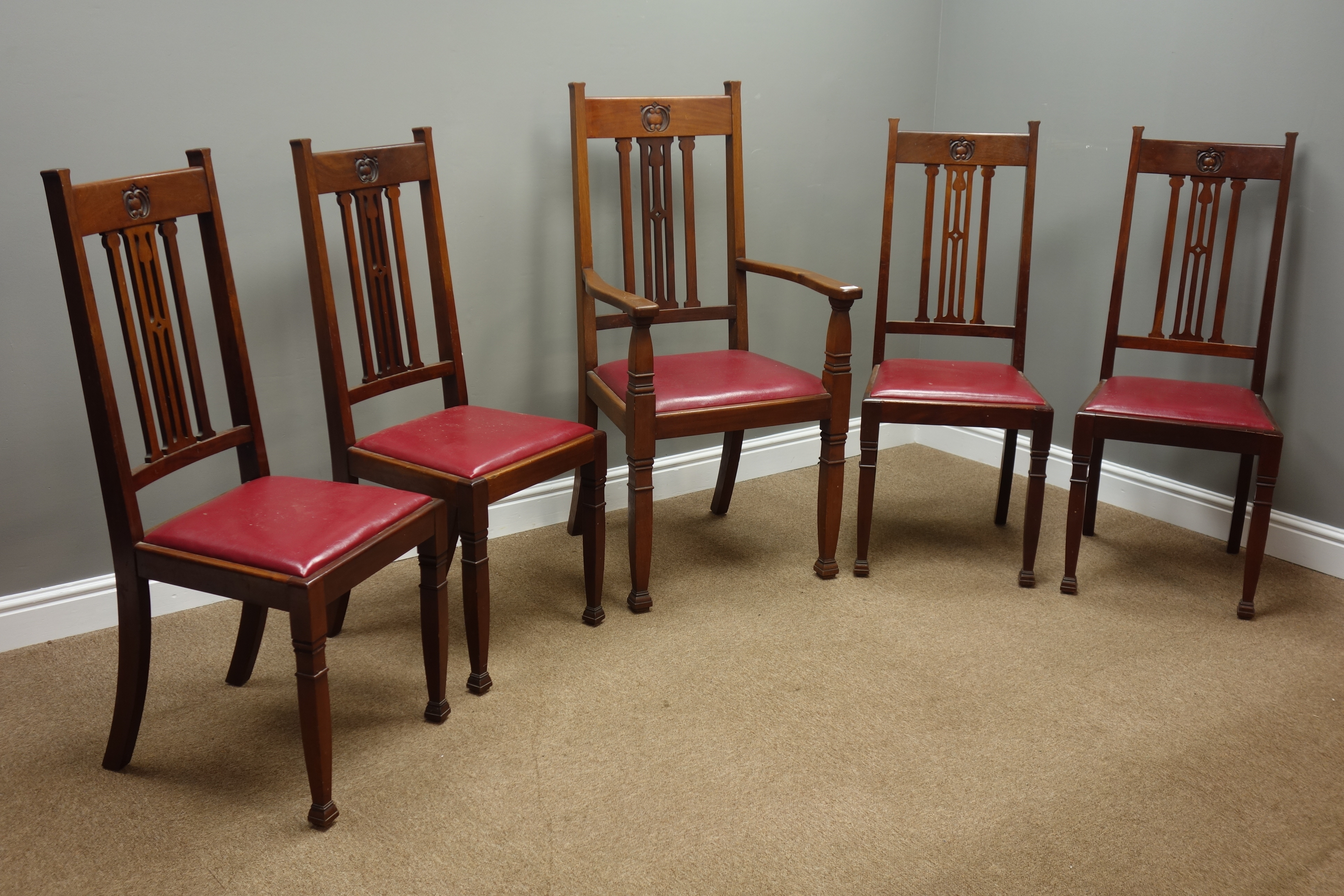 Arts and Crafts period set five (4+1) walnut dining chairs with carved motif,