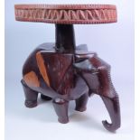 Tribal hardwood stool with circular carved top on elephant base,