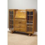 Early 20th century oak bureau bookcase, centre fall front above three drawers,
