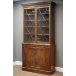 Early 20th century mahogany bookcase on cupboard, moulded cornice with strap work frieze,