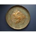 Large Eastern embossed copper circular plaque depicting a hunting scene,