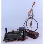 Model of an 0-4-0 steam locomotive and a part brass model of a man on a Penny Farthing bicycle (2)